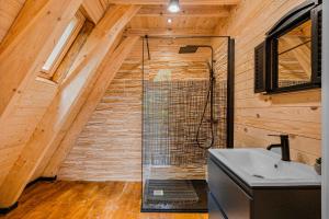 a bathroom with a shower and a sink at Cabanele Sașilor in Cisnădioara +74 photos