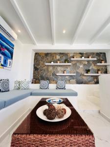 a room with a table with a plate of food at Arlene Suites in Mesaria