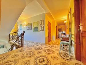 a hallway with a staircase with a tile floor at Willa Tradycja in Łeba