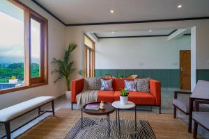 a living room with a couch and a table at Olive Hotel Chikkamagalur by Embassy Group in Jāmb