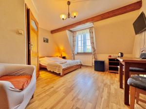 a bedroom with two beds and a desk and a window at Willa Tradycja in Łeba