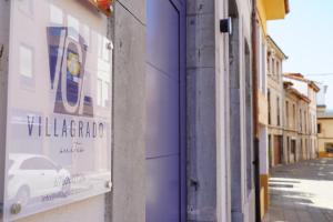 a sign on the side of a building that reads villanderado exile at VILLAGRADO Suites in Grado