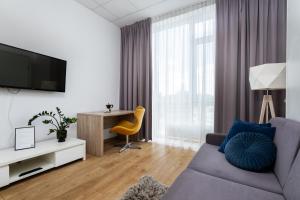 a living room with a couch and a tv at ALE Jerozolimskie Varsovia Apartments in Warsaw