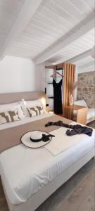 two beds in a bedroom with a hat on the bed at Paxos Dream House in Vlachopoulátika