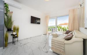 a white living room with a white couch and a window at 3 Bedroom Beautiful Home In Maslenica in Maslenica