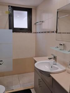 a bathroom with a sink and a window at Lama's Residence in Nicosia +9 photos
