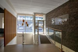 a lobby of a store with a sign on a brick wall at Hotel Klettur in Reykjavík
