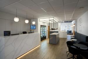 an office lobby with a reception desk and chairs at Hotel Klettur in Reykjavík +50 photos