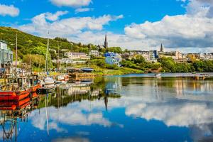 a harbor with boats in the water and a city at Dooneen House in Clifden
