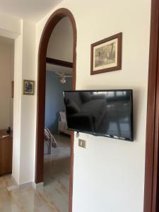 マルツァメミにあるCasa Artemisiaの壁に薄型テレビが取り付けられたリビングルーム