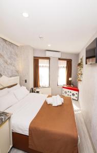 a bedroom with a large bed with white sheets at Kupa HOTEL in Istanbul