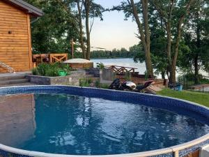 a large swimming pool in a yard next to a house at Biwak Na Skarpie in Wola