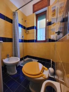 a bathroom with a toilet and a sink at Il Parco Passolara in Acciaroli