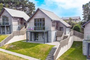 a large house with a porch and a yard at House 28 in Looe