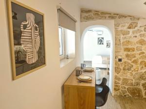 a room with a table and a painting on the wall at Paxos Dream House in Vlachopoulátika +28 photos