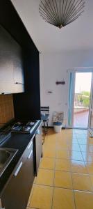 a kitchen with a sink and a stove top oven at H2o casa vacanza in Ascea
