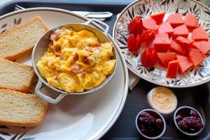 a table topped with a plate of food with eggs and toast at Glamping El Ocaso in Zipaquirá +33 photos
