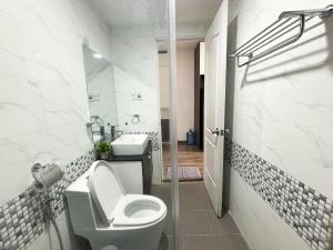 a white bathroom with a toilet and a sink at Modern Garden Apt by Dragon bridge in Da Nang +31 photos