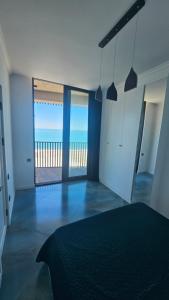 a bedroom with a bed with a view of the ocean at Bristol in Kvariati