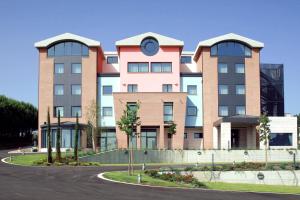 a large building with a clock on top of it at don guglielmo panoramic hotel & spa in Campobasso