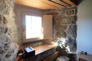 a window in a room with a stone wall at Lieux M - La petite maison in Saint-Pierre-Eynac