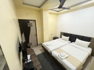 Ένα ή περισσότερα κρεβάτια σε δωμάτιο στο Royal Park Residency