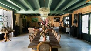 a dining room with a long table and chairs at Domaine du Turbais in Luynes