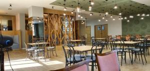 a restaurant with tables and chairs in a room at Hotel Venec in Debar