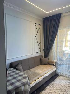 a bedroom with a couch and a large window at بورتو مطروح - Porto Matrouh in Marsa Matruh