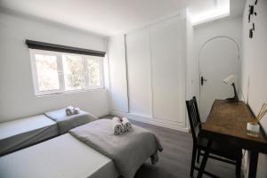 A bed or beds in a room at The Tree House Tenerife