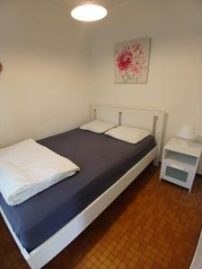 a bedroom with a bed with two pillows on it at Coquelicot in Waulsort