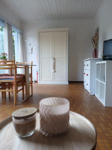 a living room with a table and a couch and a chair at Coquelicot in Waulsort
