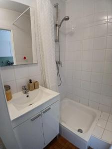 a bathroom with a sink and a shower and a tub at Coquelicot in Waulsort