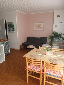 a living room with a table and a couch at Coquelicot in Waulsort +2 photos