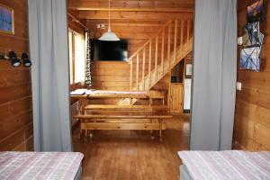 a room with a staircase in a wooden house at Ounasloma Holiday Cottages in Enontekiö