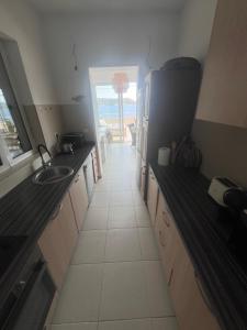 a kitchen with a sink and a refrigerator at Sea View Apartments in Herceg-Novi +17 photos