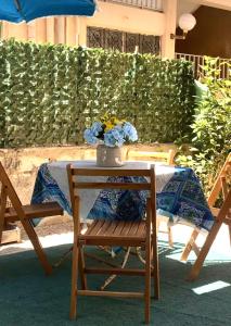 a table and chairs with a vase of flowers on it at Chalet with garden Compound group 02 in Alexandria