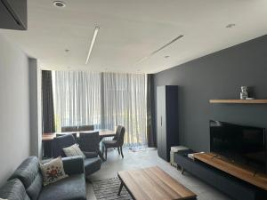 a living room with a couch and a table at Luxury Seafront Duplex Villa With Pool9 in Cesme