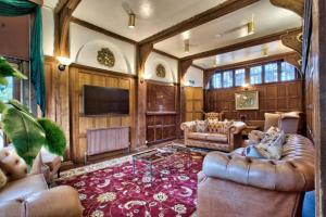 a large living room with couches and a television at Caer Beris Hotel in Builth Wells