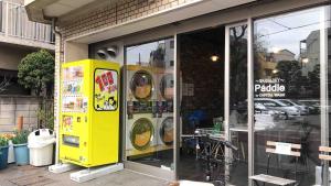 a yellow parking meter sitting outside of a store at 102 山手线近上野一站温馨新公寓 in Tokyo