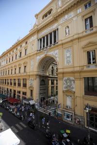 a large building with an arch in front of it at LUNA Gallery Suites in Naples