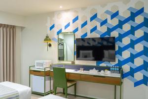 a hotel room with a sink and a mirror at Stellar Panglao in Panglao Island