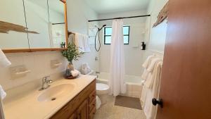 a bathroom with a sink and a toilet and a shower at The Wavestay I 4 min walk to Beach in Satellite Beach +25 photos