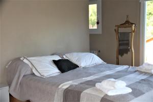 a bedroom with a bed with two towels on it at Casa Don Alfredo in San Carlos de Bariloche +10 photos