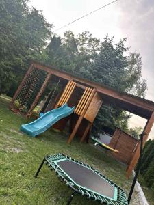 a playground with a slide and a trampoline at LUX HOUSE Roztocze 1 in Krasnobród