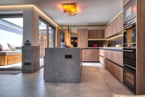 a kitchen with wooden cabinets and a counter top at Casita Moritz - Luxury - 1 min to the Beach By Lanzarote Vacation Homes in Costa Teguise