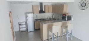 a kitchen with a counter and a refrigerator at two-bedroom apartment with a living room, kitchen and balcony in Monastir