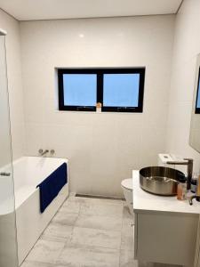 a bathroom with a tub and a sink and a toilet at Ocean Front - Port Kembla in Port Kembla +44 photos