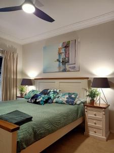 a bedroom with a bed with a ceiling fan at Ocean Front - Port Kembla in Port Kembla