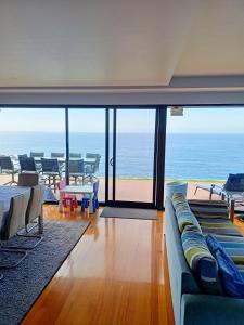 a living room with a couch and a view of the ocean at Ocean Front - Port Kembla in Port Kembla